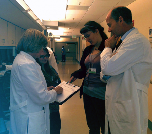 Figure 3: Dr. Mann’s UWMC clinic team huddle consisting of Vic Shorten, RN, Braelynn Atkinson, MA, Sara Murphy, PSS and Gary Mann, MD. Not shown but often present in the huddle is Darlene Brown, PCC.